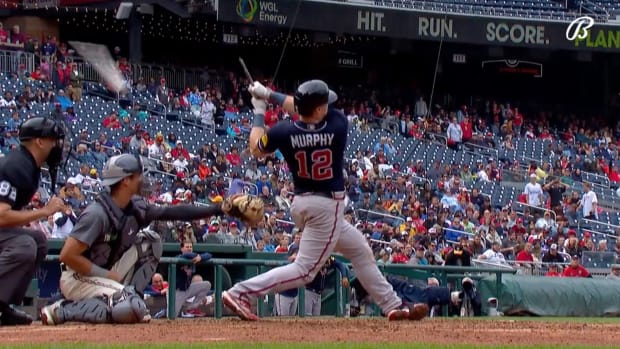 Sean Murphy follows through on his swing after breaking his bat